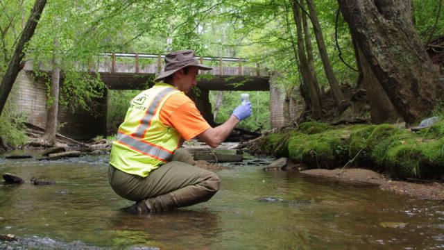 Tetra Tech collects water quality sample in an urban stream outside of Atlanta, Georgia