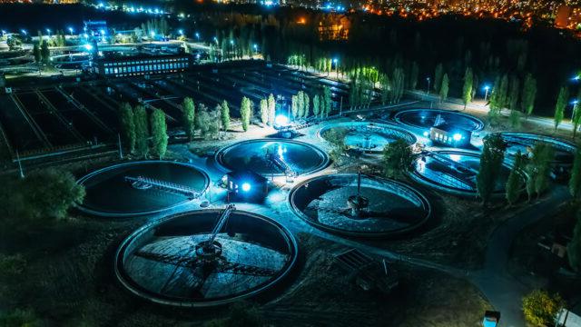 Aerial view at night of wastewater treatment plant, filtration of dirty or sewage water